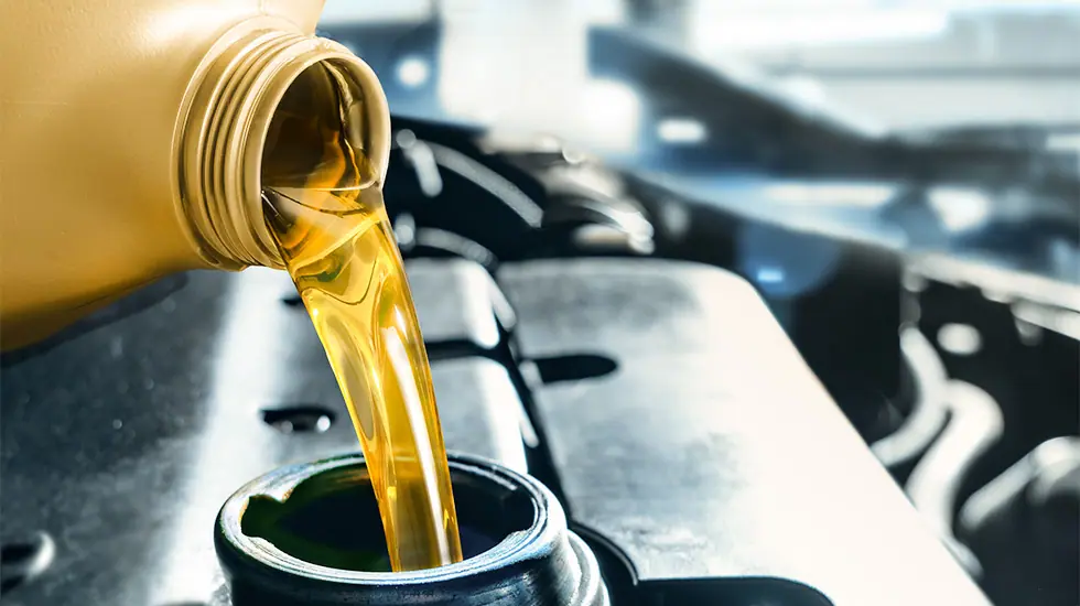 diesel fuel being poured into an engine