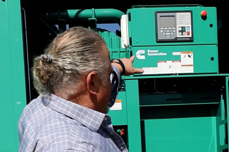 EJ Roussel showing a Cummins industrial generator control panel