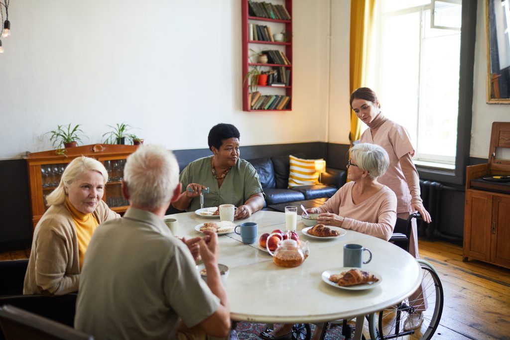 seniors sitting at a table at a senior healthcare facility