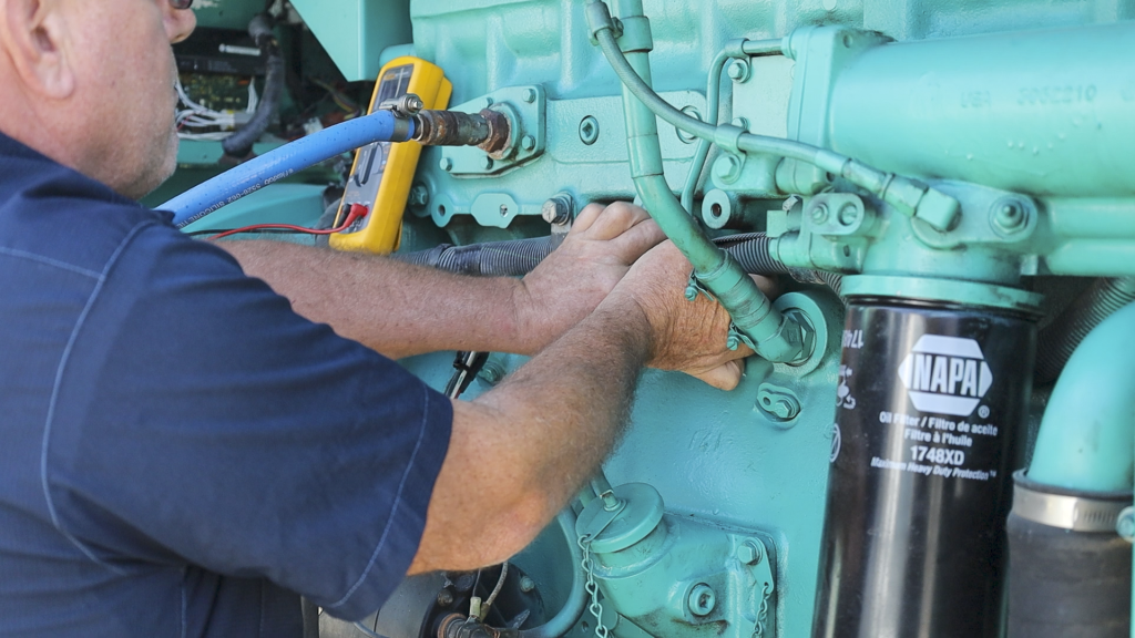 Checking the hoses and engine of the generator How to Properly Inspect a Generator Before You Buy