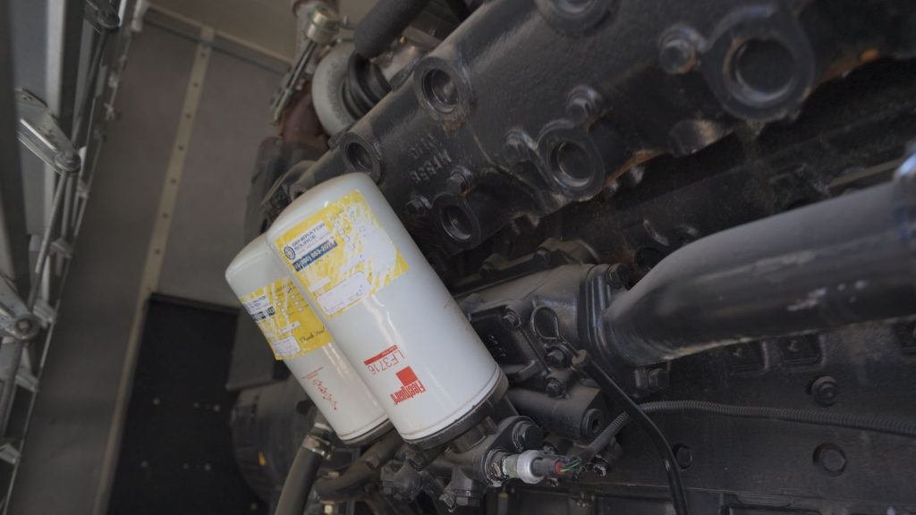 Generator engine oil and filter being replaced during maintenance