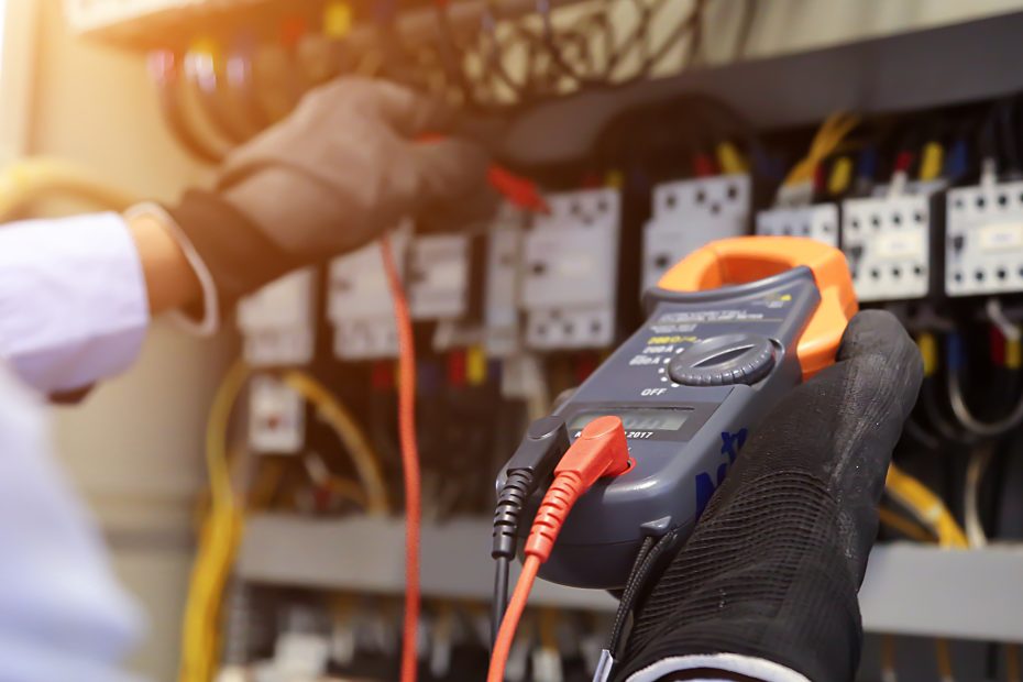 Electrician diagnosing a generator Root Causes & Strategic Mitigation for Industrial Power Failures